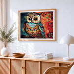 Intricate colourful owl cross stitch artwork displayed on wall as home decor