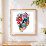 Finished intricate watercolour floral skull cross stitch artwork displayed