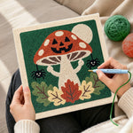 Creating handmade jack‑o‑lantern mushroom punch needle artwork