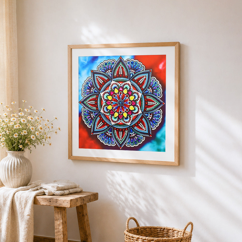 Jewel tone red and blue mandala cross stitch artwork displayed on wall as home decor