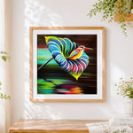 Finished kingfisher on colourful leaf cross stitch artwork displayed