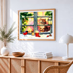 Kitten in a snowy window with robin cross stitch artwork displayed on wall as home decor