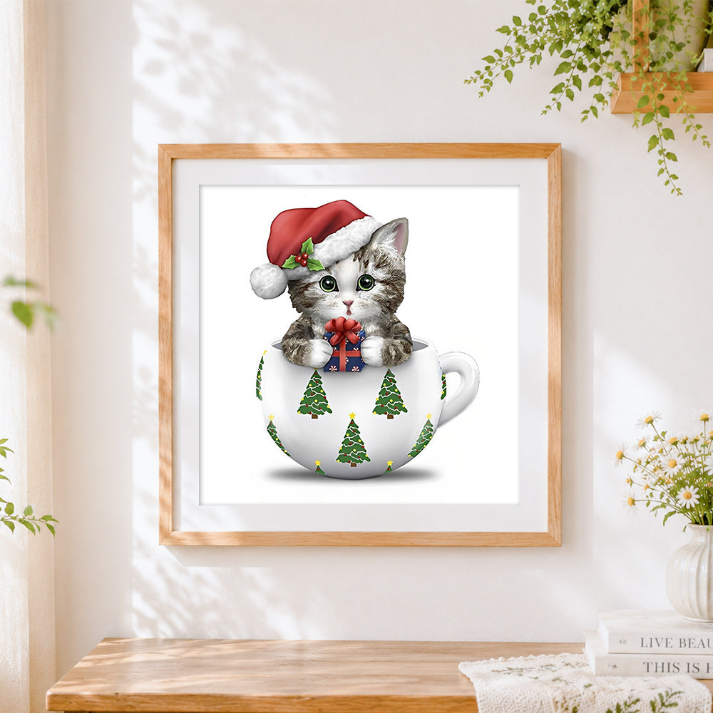 Finished kitten in a teacup with santa hat cross stitch artwork displayed
