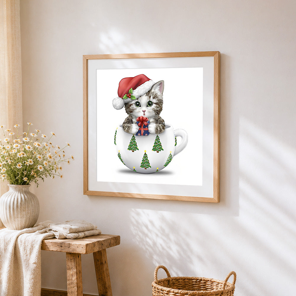 Kitten in a teacup with santa hat cross stitch artwork displayed on wall as home decor