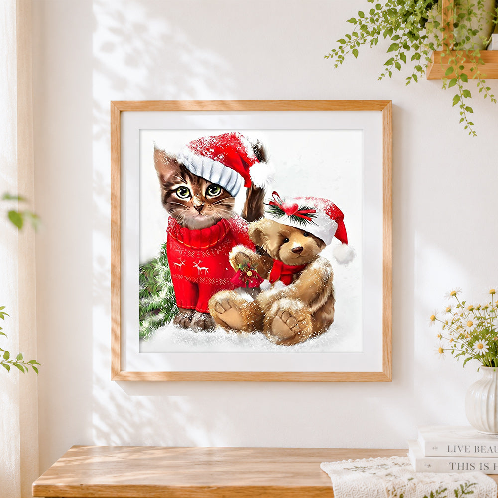 Finished kitten in christmas jumper and bear cross stitch artwork displayed