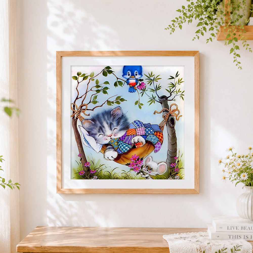 Finished kitten in hammock cross stitch artwork displayed