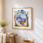 Kitten in hammock cross stitch artwork displayed on wall as home decor