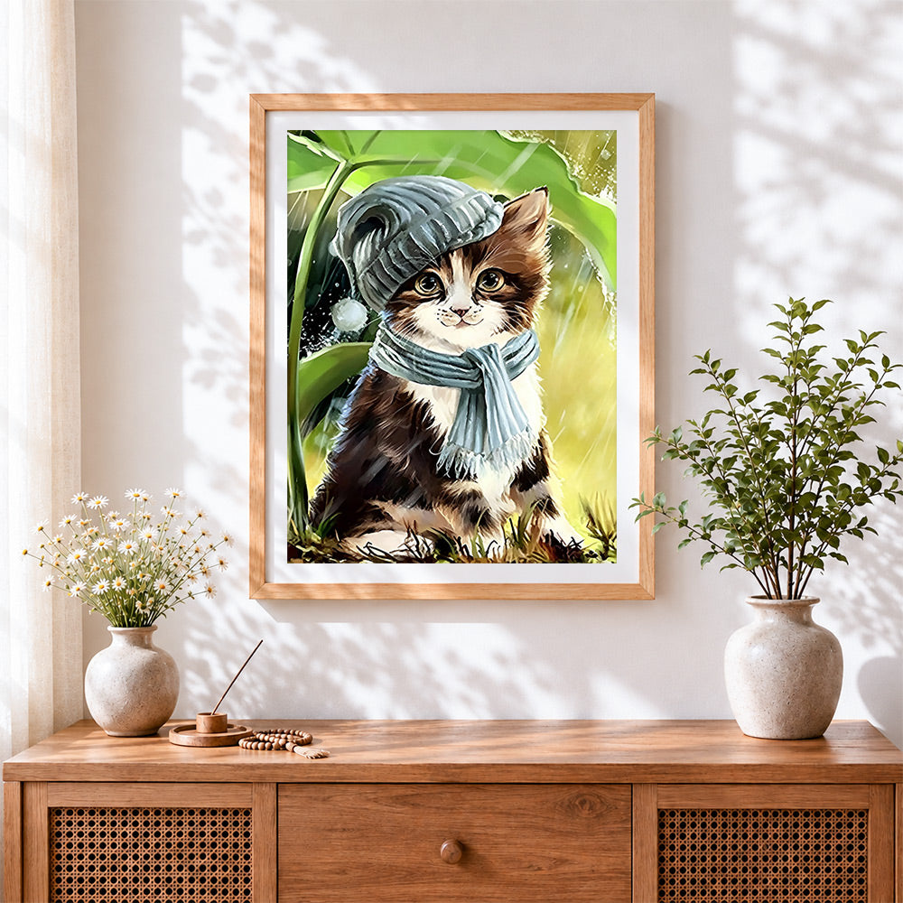 Finished kitten in winter hat and scarf cross stitch artwork displayed