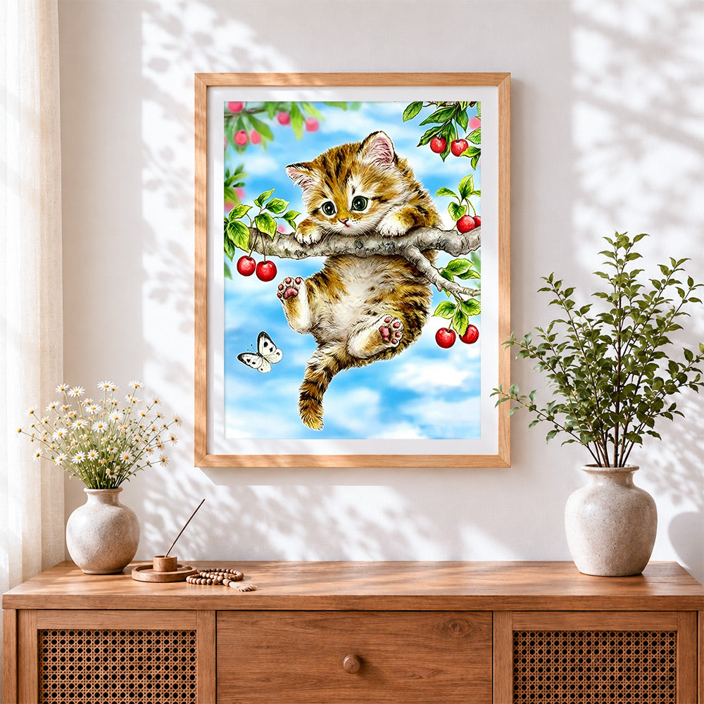 Finished kitten on cherry tree cross stitch artwork displayed
