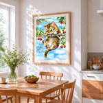 Kitten on cherry tree cross stitch artwork displayed on wall as home decor