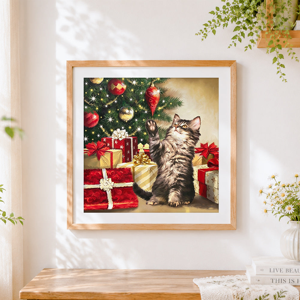 Finished kitten playing with christmas bauble cross stitch artwork displayed