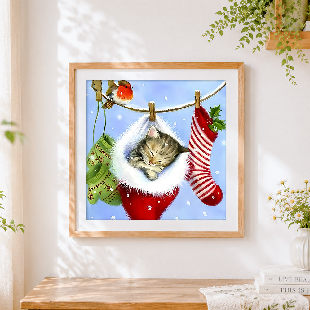 Finished kitten sleeping in christmas stocking cross stitch artwork displayed