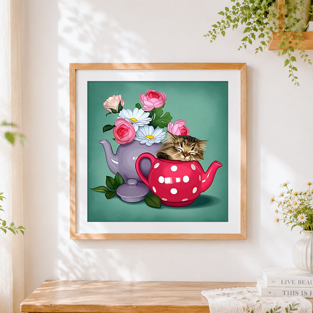 Finished kitten sleeping in teapot cross stitch artwork displayed