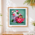 Finished kitten sleeping in teapot cross stitch artwork displayed