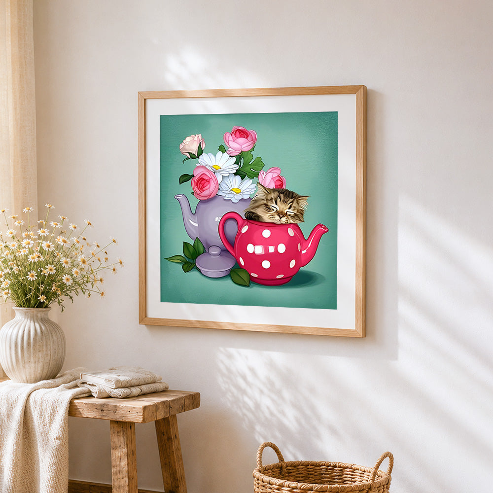 Kitten sleeping in teapot cross stitch artwork displayed on wall as home decor