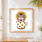 Finished kitten with sunflower and watermelon cross stitch artwork displayed