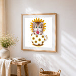 Kitten with sunflower and watermelon cross stitch artwork displayed on wall as home decor