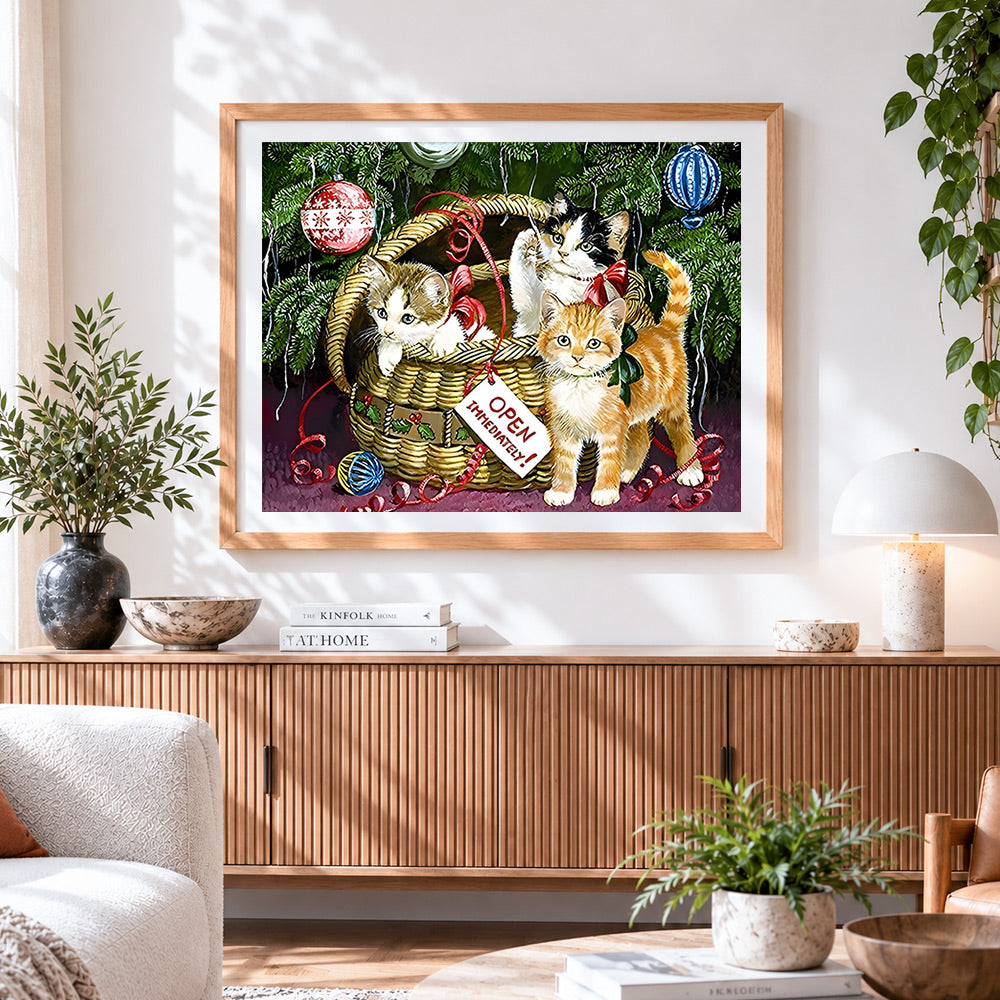 Finished kittens in a basket by the christmas tree cross stitch artwork displayed
