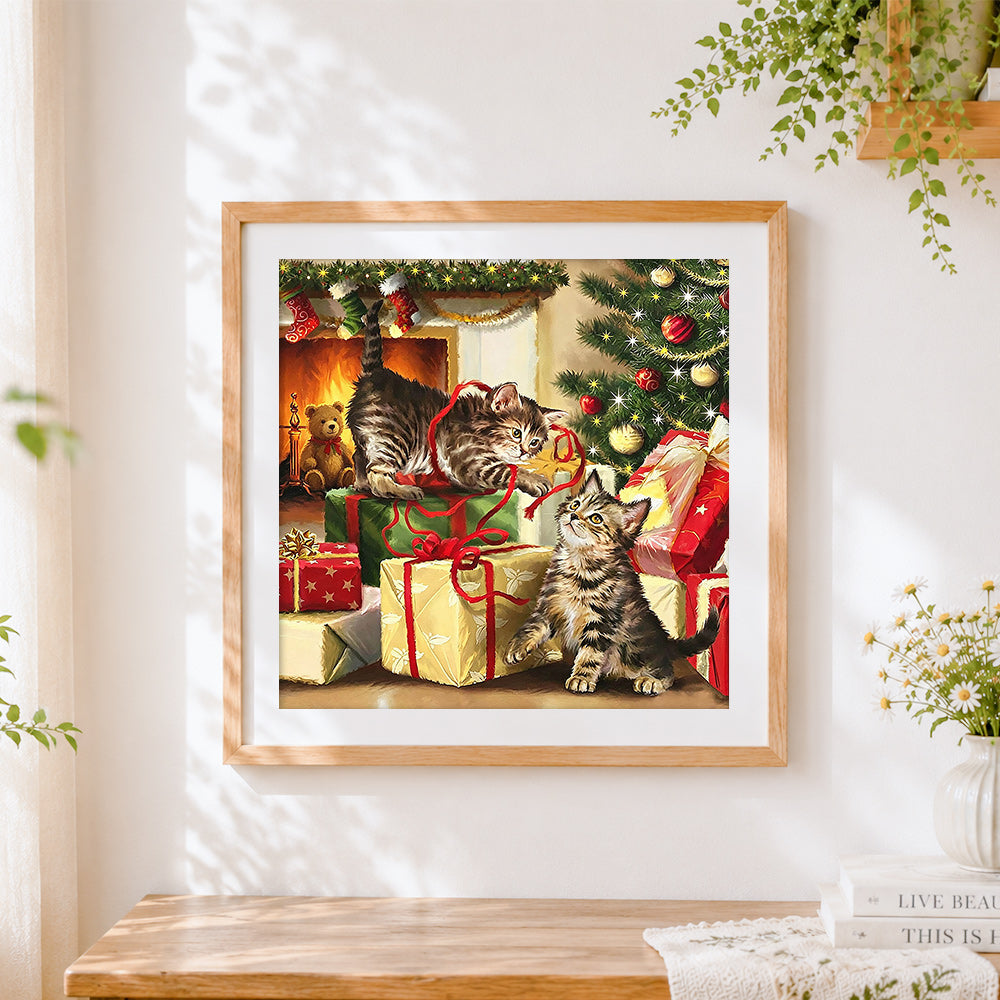 Finished kittens playing with gifts by the tree cross stitch artwork displayed