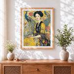 Finished lady in gold with azure peacocks cross stitch artwork displayed