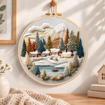 Lakeside snow town embroidery hoop wall art displayed as warm and cosy handmade home decor