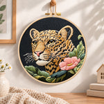 Leopard and pink wildflower embroidery hoop wall art displayed as warm and cosy handmade home decor