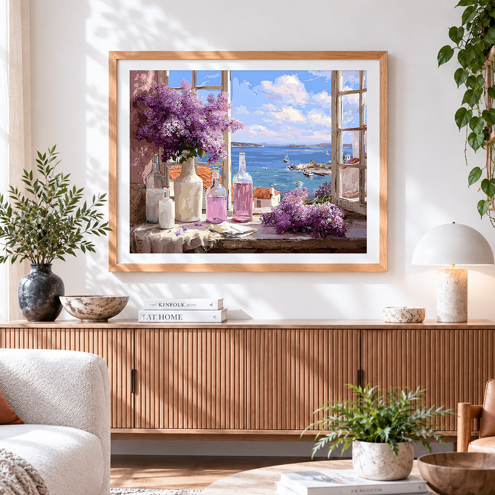 Finished lilacs in window with sea view cross stitch artwork displayed