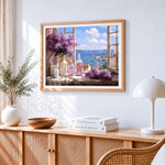 Lilacs in window with sea view cross stitch artwork displayed on wall as home decor