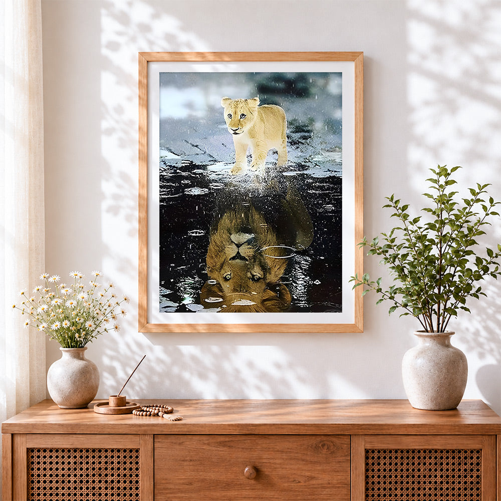 Finished lion cub reflection cross stitch artwork displayed