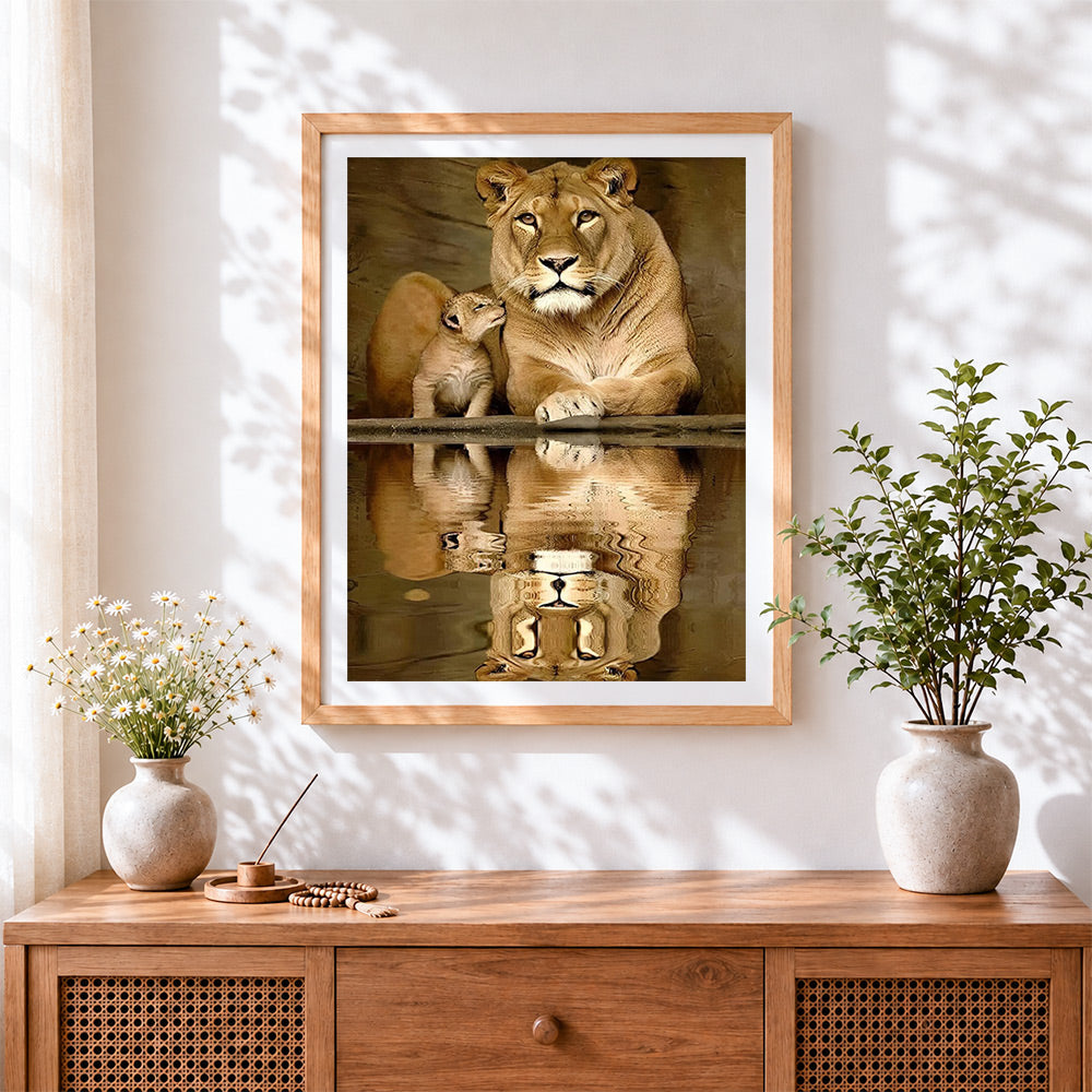 Finished lioness and cub reflection cross stitch artwork displayed
