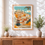 Finished lisbon tram and colourful houses cross stitch artwork displayed