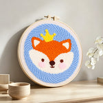 Little crown fox punch needle artwork displayed on a table