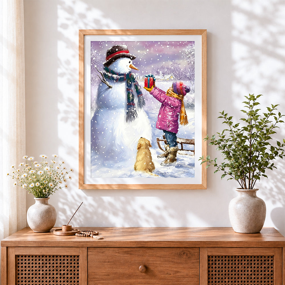 Finished little girl giving gift to snowman cross stitch artwork displayed