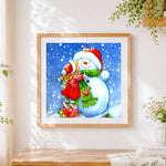Finished little girl hugging a snowman cross stitch artwork displayed