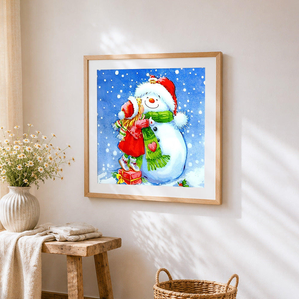 Little girl hugging a snowman cross stitch artwork displayed on wall as home decor