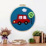 Finished little red car with tree artwork displayed on a wall