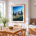 Log cabin and snowy mountains cross stitch artwork displayed on wall as home decor