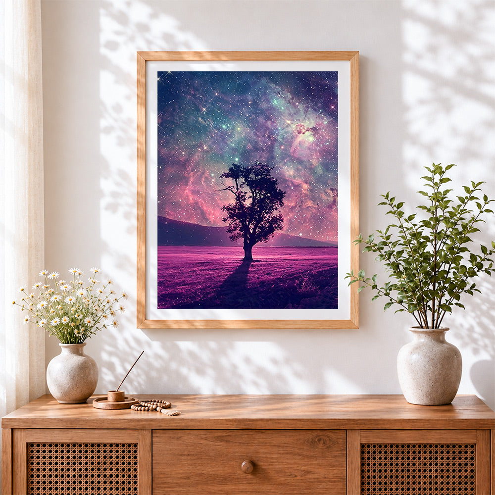 Finished lone tree under a pink galaxy cross stitch artwork displayed