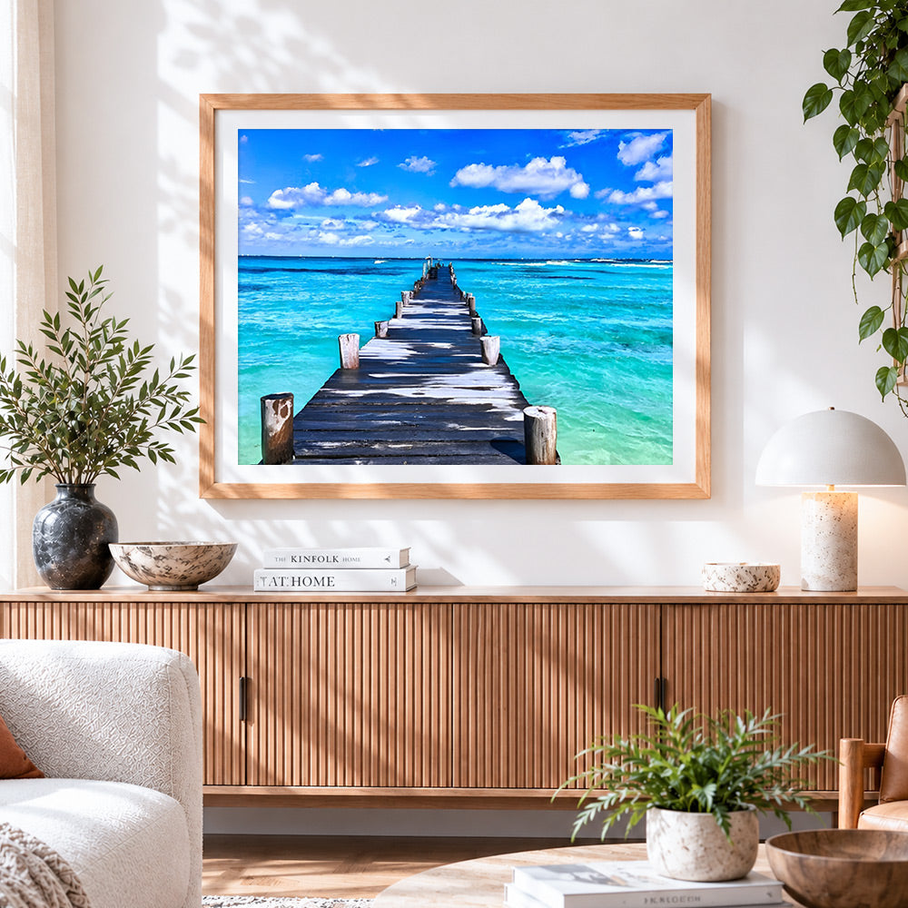 Finished long wooden pier over turquoise sea cross stitch artwork displayed