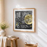 Love you to the moon and back chalkboard print cross stitch artwork displayed on wall as home decor