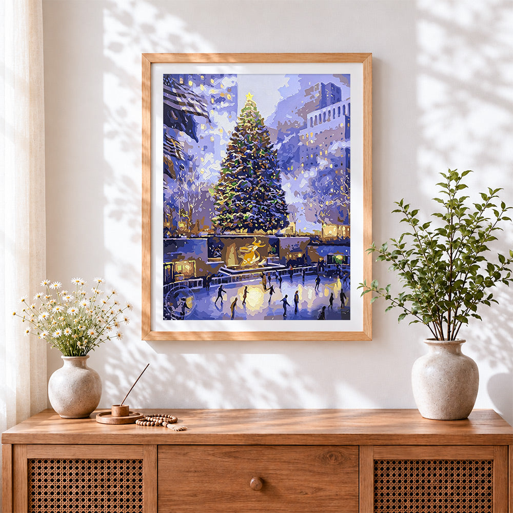 Finished magical city christmas tree and ice skating cross stitch artwork displayed