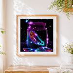 Finished magical glowing feather in a jar cross stitch artwork displayed