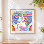 Finished magical rainbow unicorn in heart paint by numbers artwork displayed as home decor