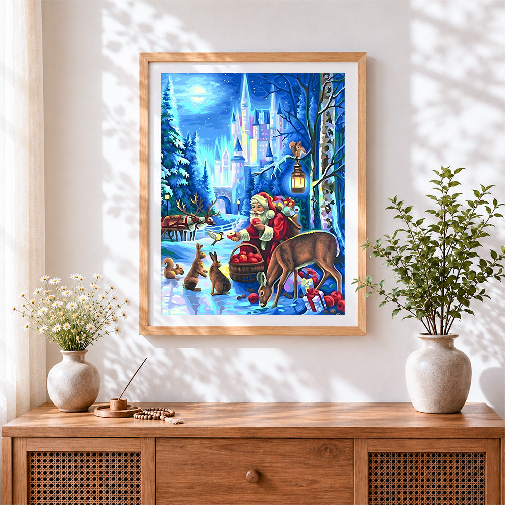 Finished magical santa feeding woodland animals cross stitch artwork displayed