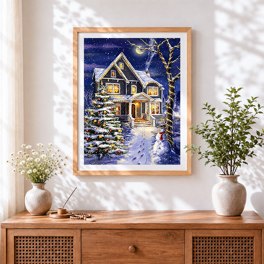 Finished magical snowy house and glowing christmas tree cross stitch artwork displayed