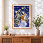 Finished magical snowy house and glowing christmas tree cross stitch artwork displayed