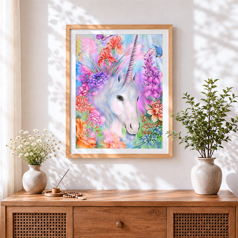 Finished magical unicorn surrounded by flowers cross stitch artwork displayed