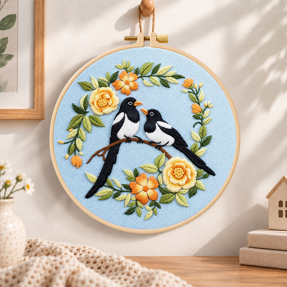 Magpie pair with yellow flowers embroidery hoop wall art displayed as warm and cosy handmade home decor