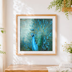 Finished majestic blue peacock cross stitch artwork displayed