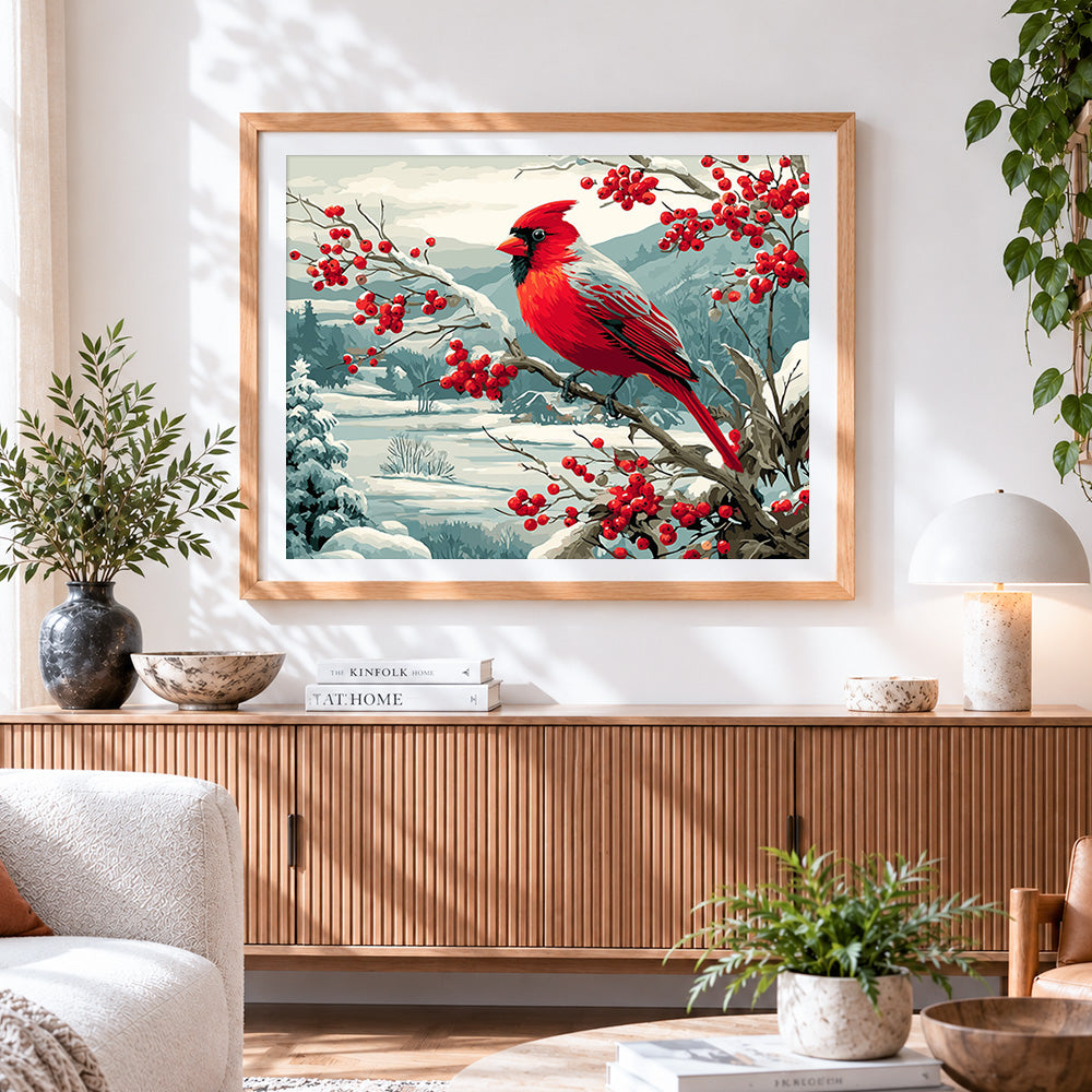 Finished majestic cardinal in a snowy winter landscape cross stitch artwork displayed